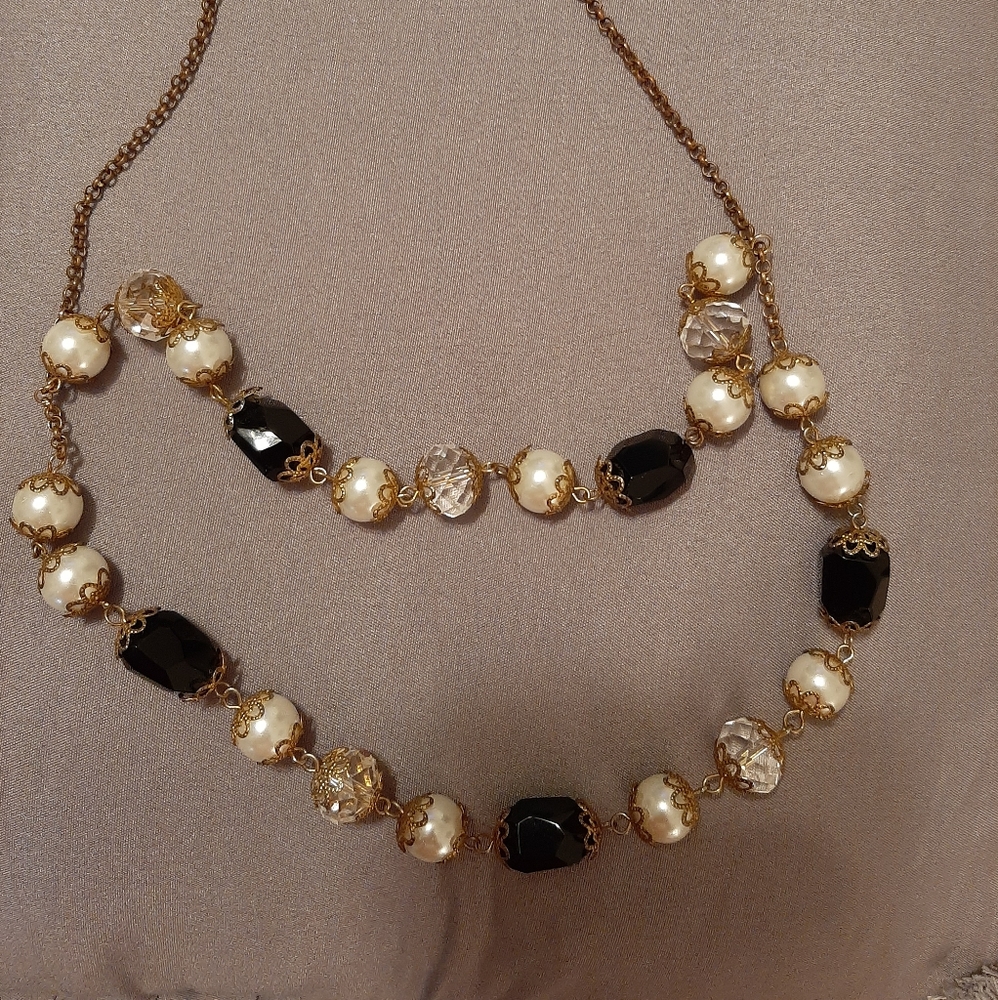 Black, pearl, gold double strand statement piece for a classy look